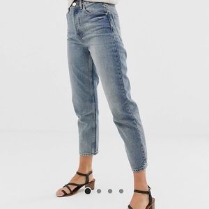 High waisted, stone wash straight leg denim jeans.